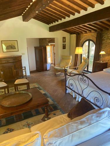 a bedroom with a bed and a living room at il MOLENDINO in Calci