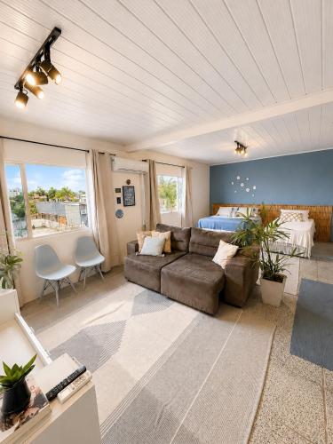 a living room with a couch and a bed at Pousada Surf na Guarda in Guarda do Embaú
