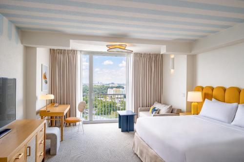 a hotel room with a bed and a large window at Renaissance Orlando Resort - Disney Springs Area - Free Shuttle & Early Entry to Disney Theme Parks in Orlando