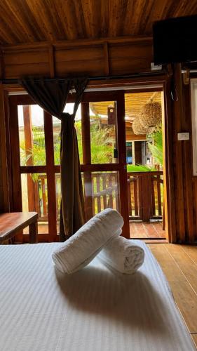 a bed with two pillows on it in a room at Hotelito Villas Holbox - Self Check In in Holbox Island