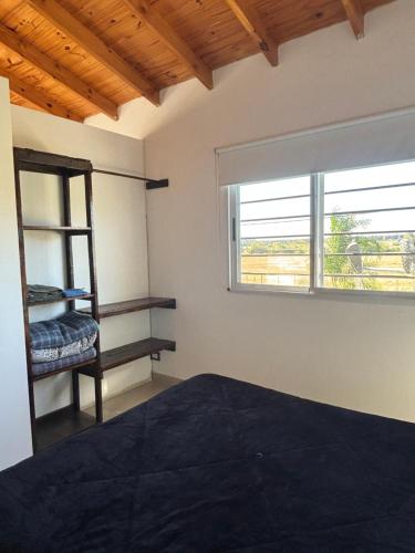 a bedroom with a bed and a window at Los Talares in Baradero