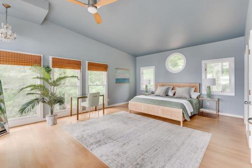 a bedroom with a bed and two windows at Scenic, Spacious Riverside Retreat Ropeyarn in Deltaville