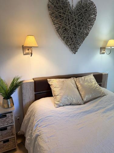 a bedroom with a bed with a heart on the wall at Bavella in Zonza