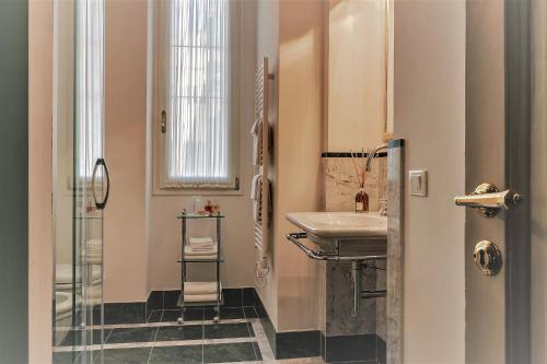 a bathroom with a sink and a mirror at Unione Charme in Florence