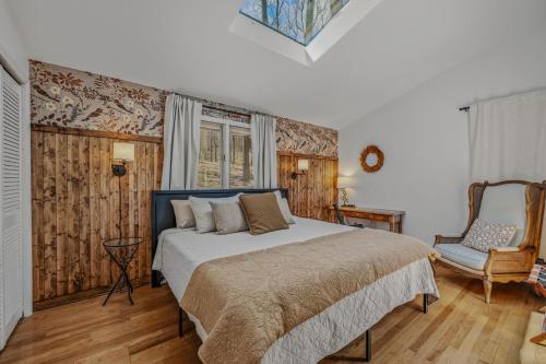 a bedroom with a bed and a chair at Ma-ple Haven --Wifi, Fireplace, Deck, Fire Pit, Family Friendly, Game Room, Pool Access in Berkeley Springs