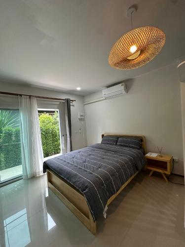 a bedroom with a bed and a large window at Golden Moon Resort in Ban Madua Wan