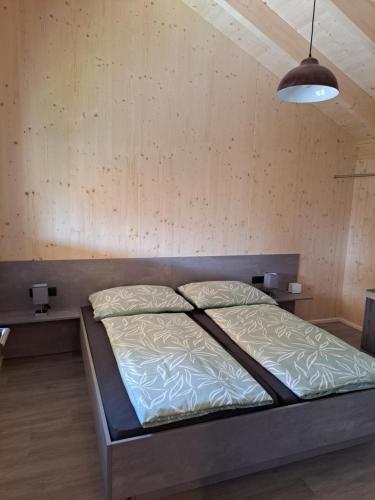 a bedroom with a bed and a large lamp at Ferienhaus Brunner in Höchst