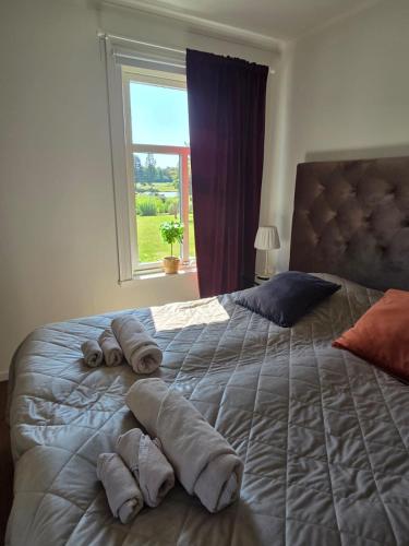 a bedroom with a large bed with towels on it at 3A Centralt Boende i Dala-Floda! in Djuras