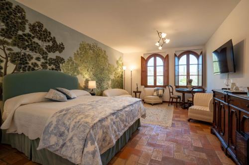a bedroom with a bed and a living room at Tolaini Winery Suites in Castelnuovo Berardenga