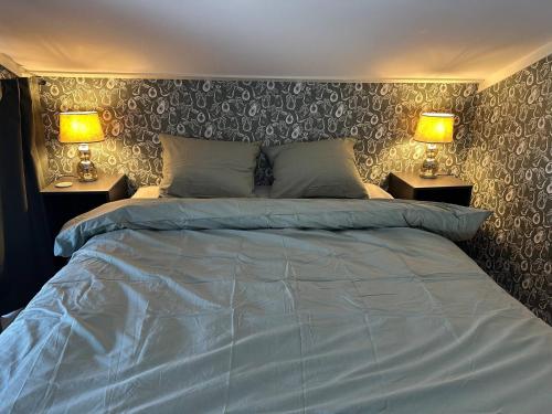a bedroom with a large bed with two lamps at Happy stay apartment in Vallda