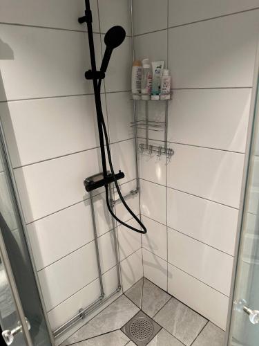 a shower with a blow dryer in a bathroom at Happy stay apartment in Vallda