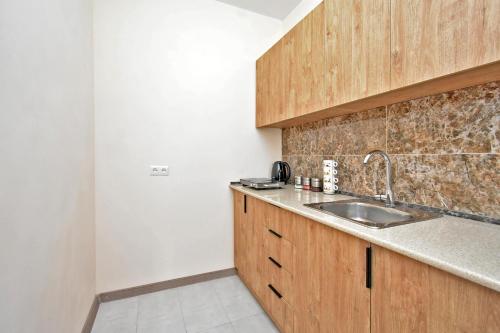 a kitchen with a sink and a counter top at Zvartnots International Hotel in Pʼarakʼar