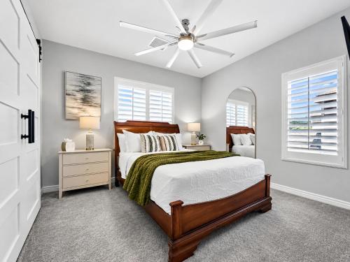 a bedroom with a bed and a ceiling fan at The Jade House Queen Creek in Queen Creek