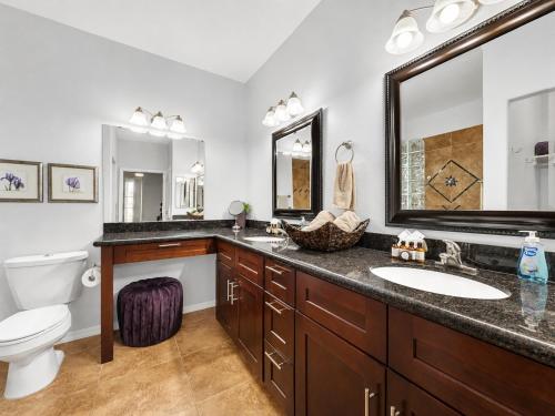 a bathroom with a sink and a toilet and a mirror at Southern #1083 Mesa in Mesa