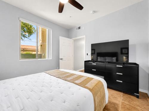 a bedroom with a large bed and a television at Southern #1083 Mesa in Mesa