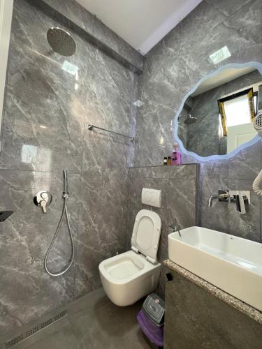 a bathroom with a toilet and a sink at Azzurre Premium Aparthotel in Sarandë