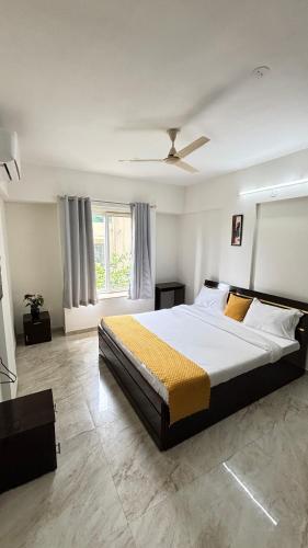 a bedroom with a large bed and a window at Nestoria Corporate Services in Pune