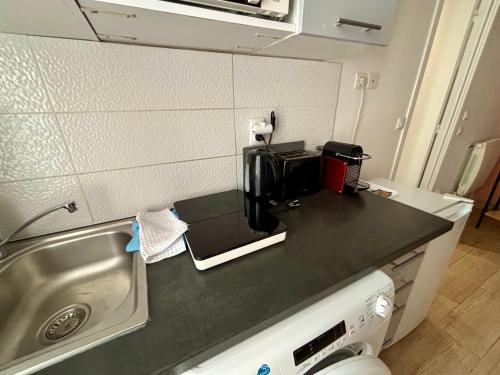 a kitchen counter with a coffee maker on it at Duplex moderne & calme à Malakoff in Malakoff