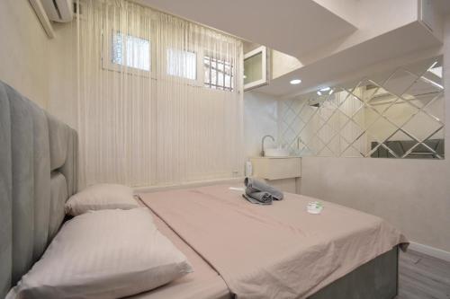 a small room with a bed and a mirror at Old Yerevan Guesthouses in Yerevan