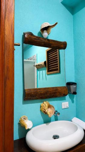 a bathroom with a mirror and a sink at Hotelito Villas Holbox - Self Check In in Holbox Island