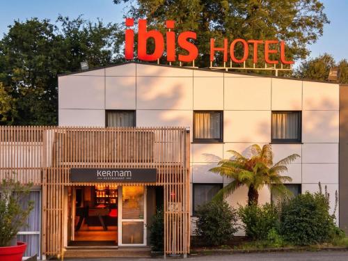a hotel with a sign on top of a building at ibis Quimper in Quimper