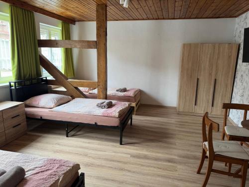 a bedroom with two bunk beds and a table at Monteurhaus Salzwedel in Salzwedel