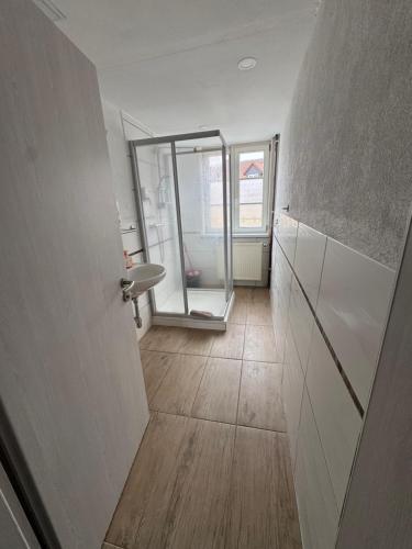 a hallway with a bathroom with a sink and a mirror at Monteurhaus Salzwedel in Salzwedel