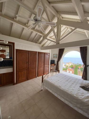 a bedroom with a bed and a large window at Villa Vue Panoramique sur les îles de Lérins in Saint-Raphaël