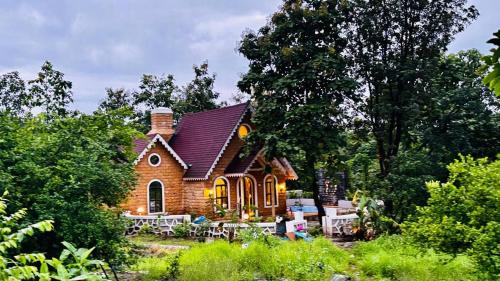 a small house with tables and chairs in front of it at StoneHaven 1BHK pvt Pool in Agashi