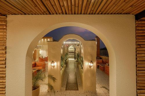 an archway in a restaurant with plants at The Roseville Grand Near Chandigarh University-Rayat Bahra University Kharar Chandigarh in Kharar