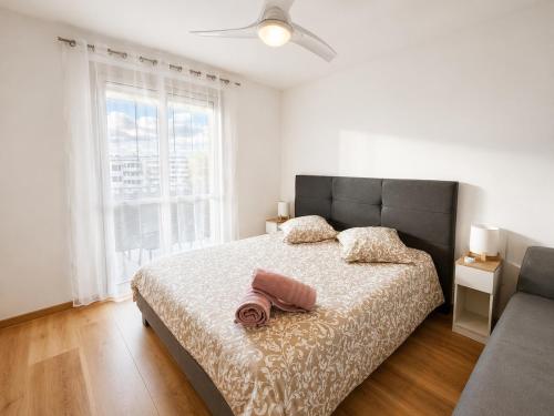 a bedroom with a bed and a large window at "LE PANORAMIQUE" en plein centre in Port-de-Bouc