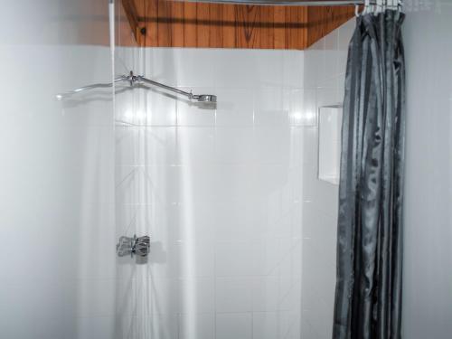 a bathroom with a shower with a shower curtain at Warburton Holiday Park in Warburton