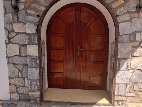 a wooden door in a stone wall at Villa Galicnik in Galičnik