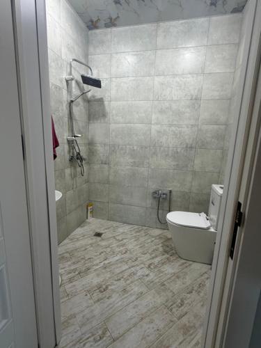 a bathroom with a tub and a toilet and a sink at Sunset Garden Apartment 3 in Bilgah