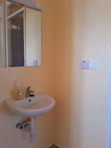 a bathroom with a sink and a mirror at BnB in Homa Bay
