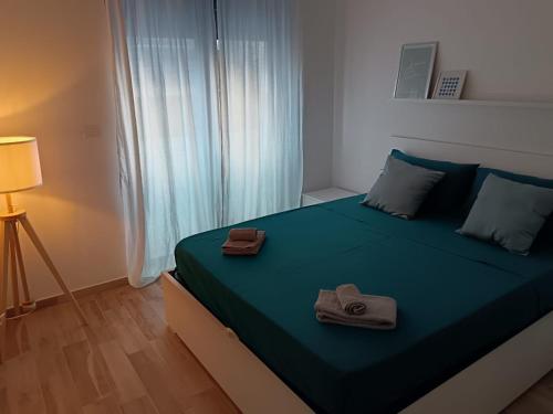 a bedroom with a bed with two towels on it at La Maison de Roland in Pescara