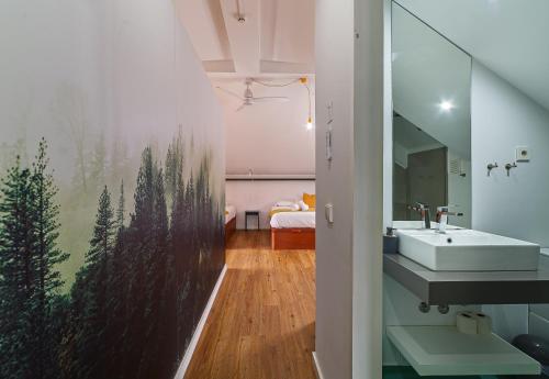 a bathroom with a sink and a mirror at BeSmart Suites with Private WC by Home Sweet Home Aveiro in Aveiro