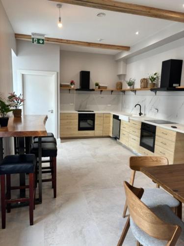 a large kitchen with a table and chairs and a sink at The Gate House in Galway