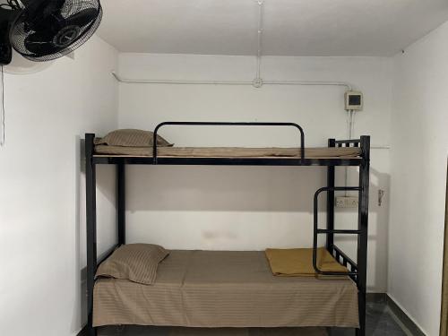 a room with two bunk beds in it at Sleek Haven Dormitory in Meppādi