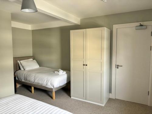 a bedroom with a bed and a closet and a cabinet at The Gate House in Galway