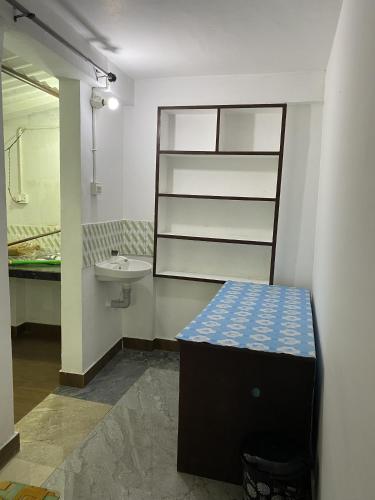 a bathroom with a sink and a counter in it at Sleek Haven Dormitory in Meppādi