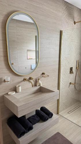 a bathroom with a sink and a mirror at Spacious villa, sea view in Cabo Negro