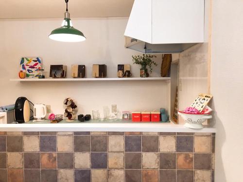 A kitchen or kitchenette at Hiroshima Guesthouse HARU