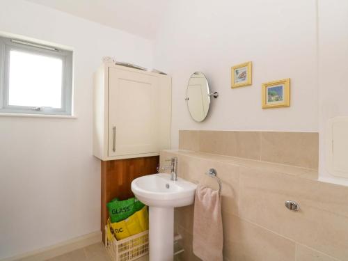 a bathroom with a sink and a mirror at Craigard in Aberfeldy