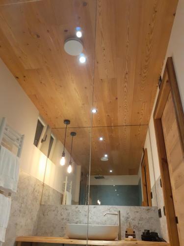 a bathroom with a sink and a wooden ceiling at Affittacamere Sbulìa in Santo Stefano di Cadore