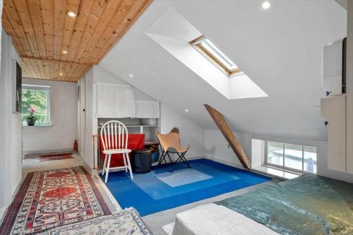 a bedroom with a blue floor in a attic at 4025-Borre-Liselundvej-20 in Borre