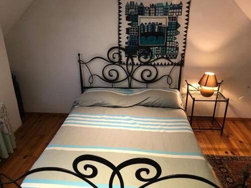 a bedroom with a bed with a black head board at Bergerie - piscine privée in Cadrieu