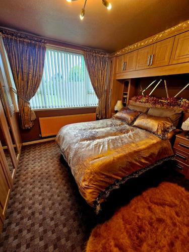 a bedroom with a large bed and a large window at The Little Green Hideaway in Fivemiletown