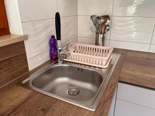 a kitchen sink with a dish strainer next to it at Apartments Valun in Valun