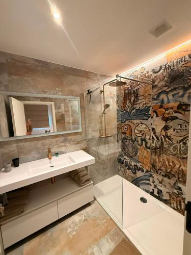 a bathroom with a sink and a shower at Cit'Art in Namur